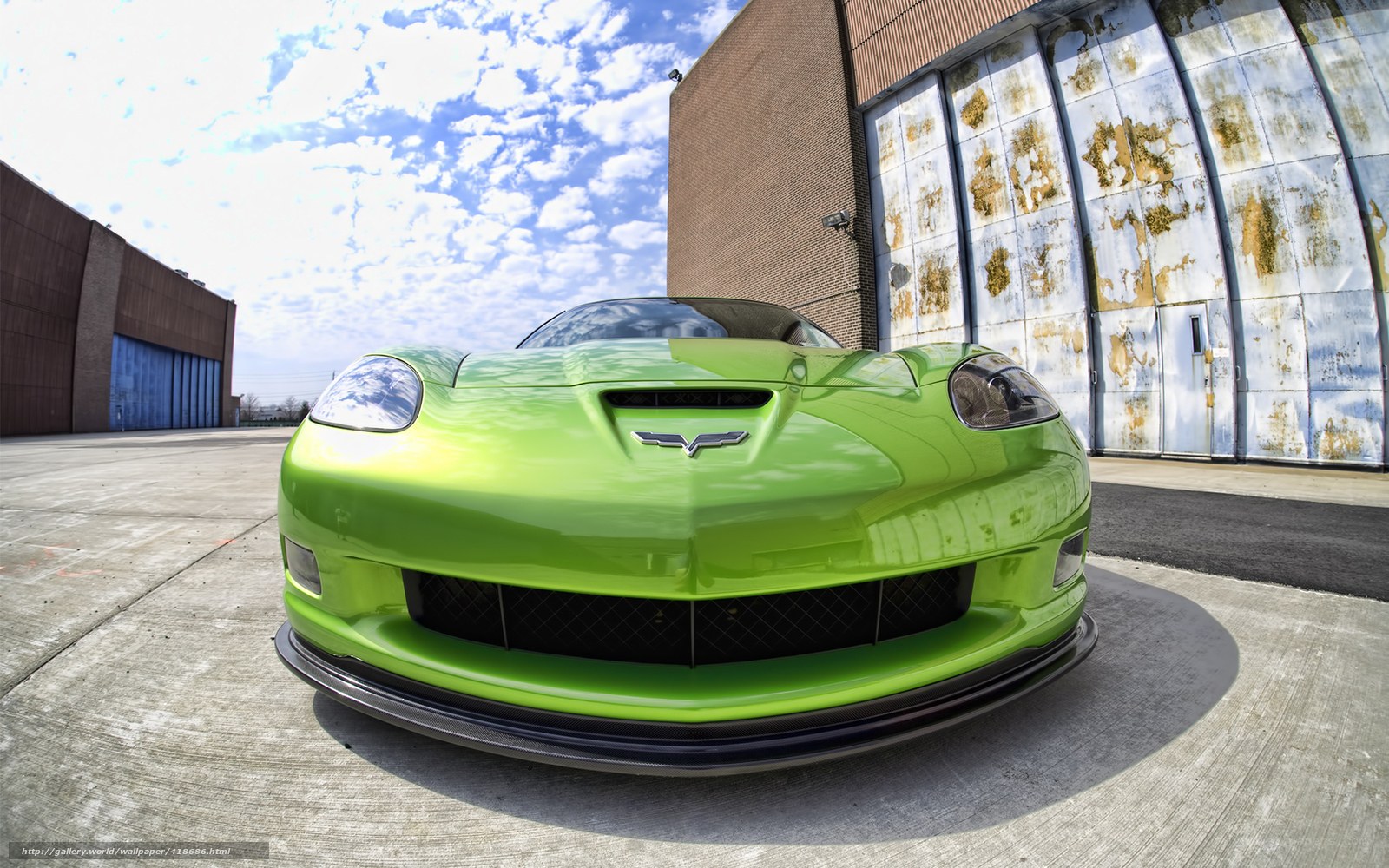 Green Corvette in industrial lot