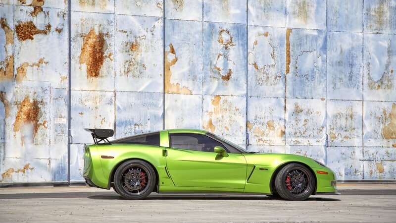 green corvette on rusted wall