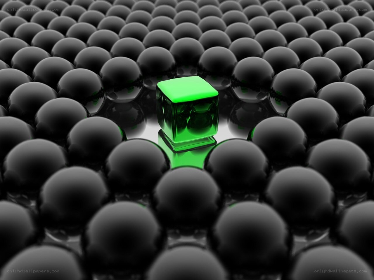 green cube among black spheres