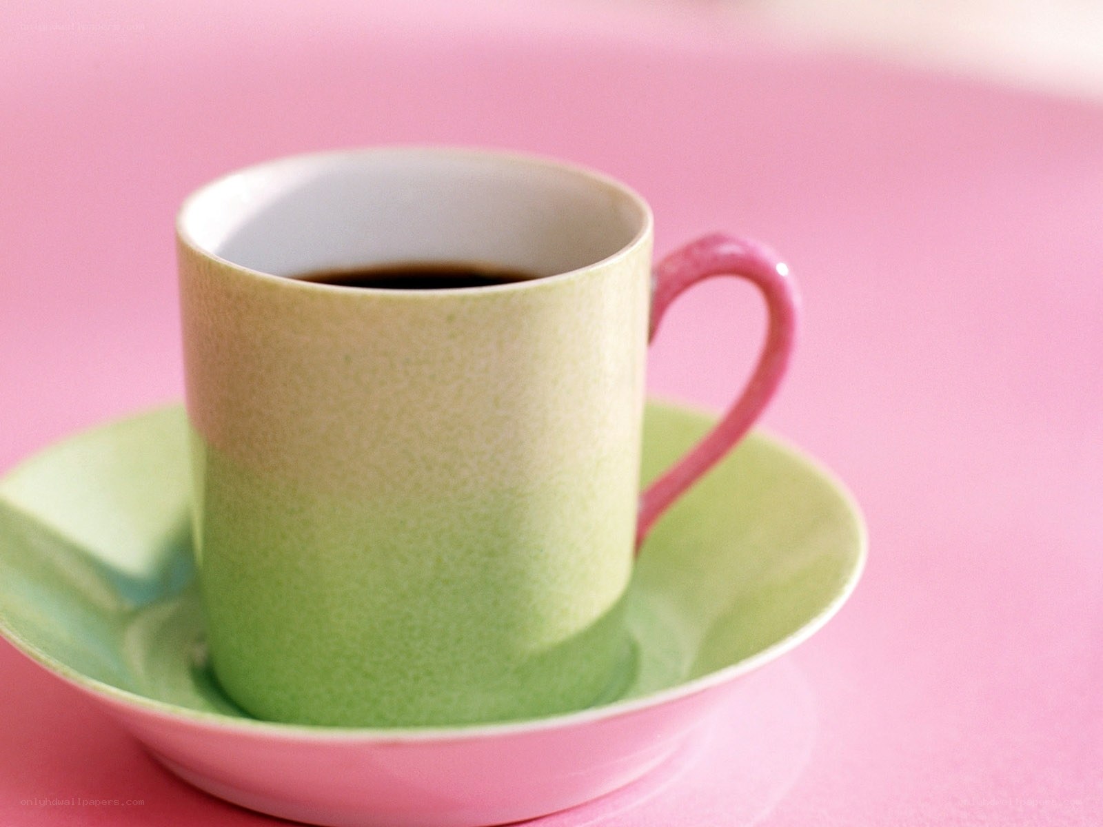 green cup on pink background