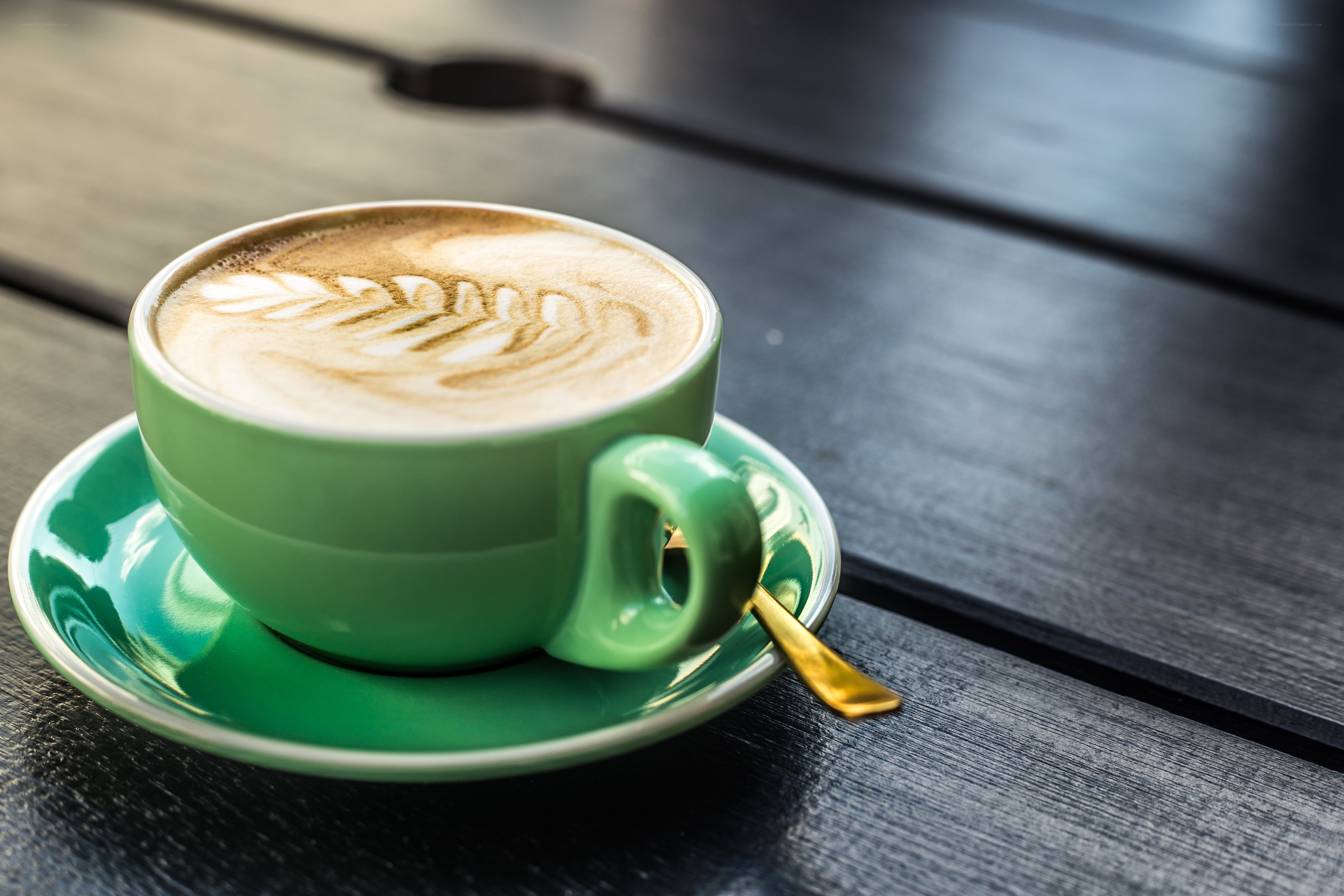 Green cup with latte art