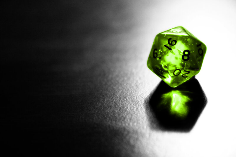 Green D20 Dice on Dark Surface