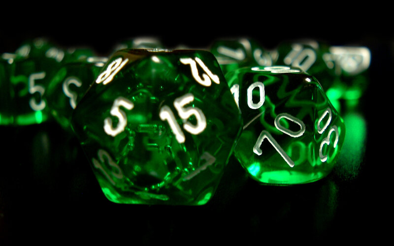 green dice on black background
