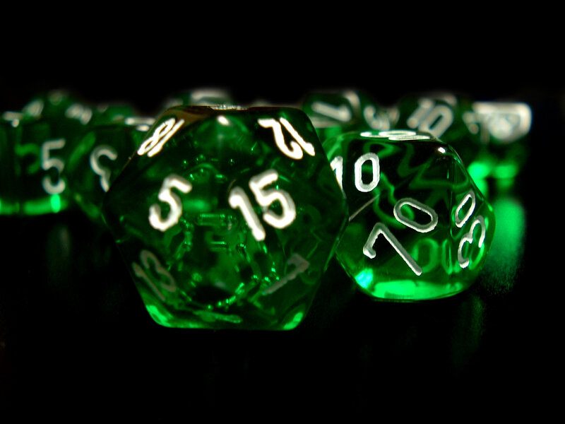 Green dice on black background