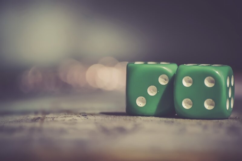 Green Dice on Surface