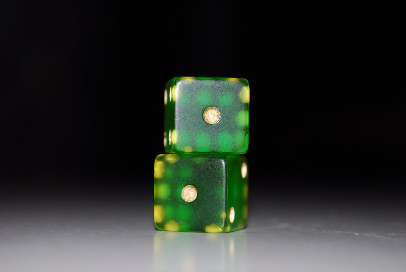 Green dice stacked on surface