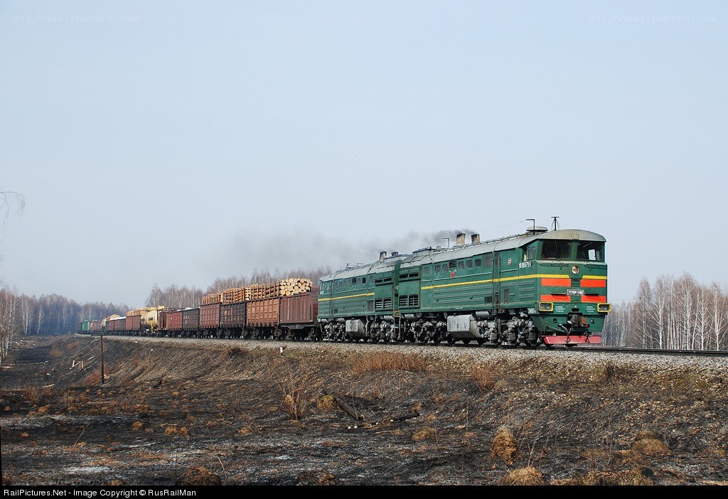 Green diesel locomotive pulling freight