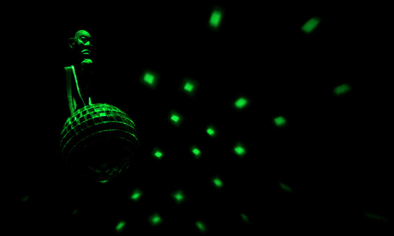 green disco ball in dark room
