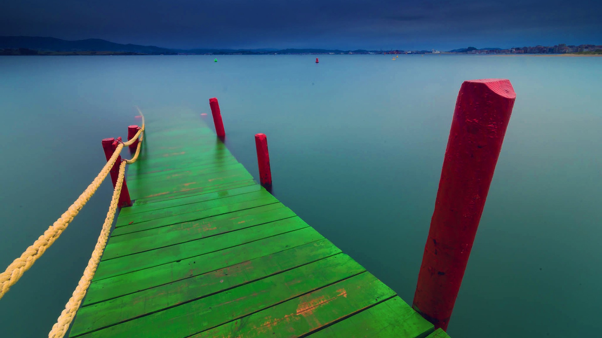 Green dock on calm water