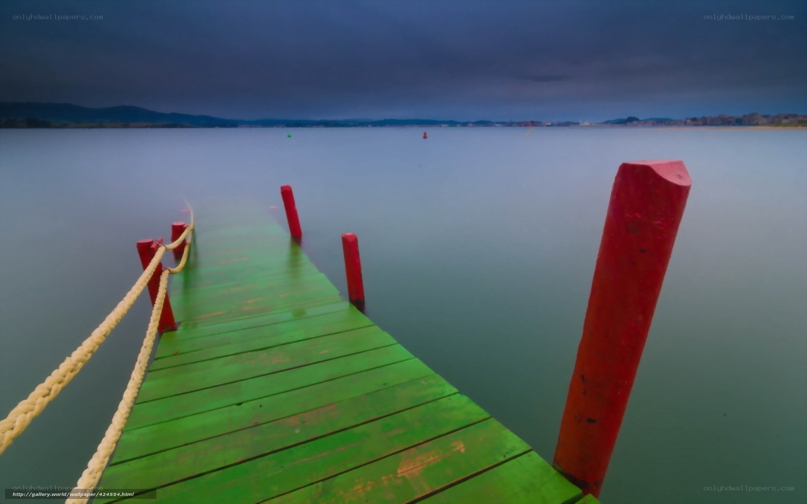 Green dock on calm water