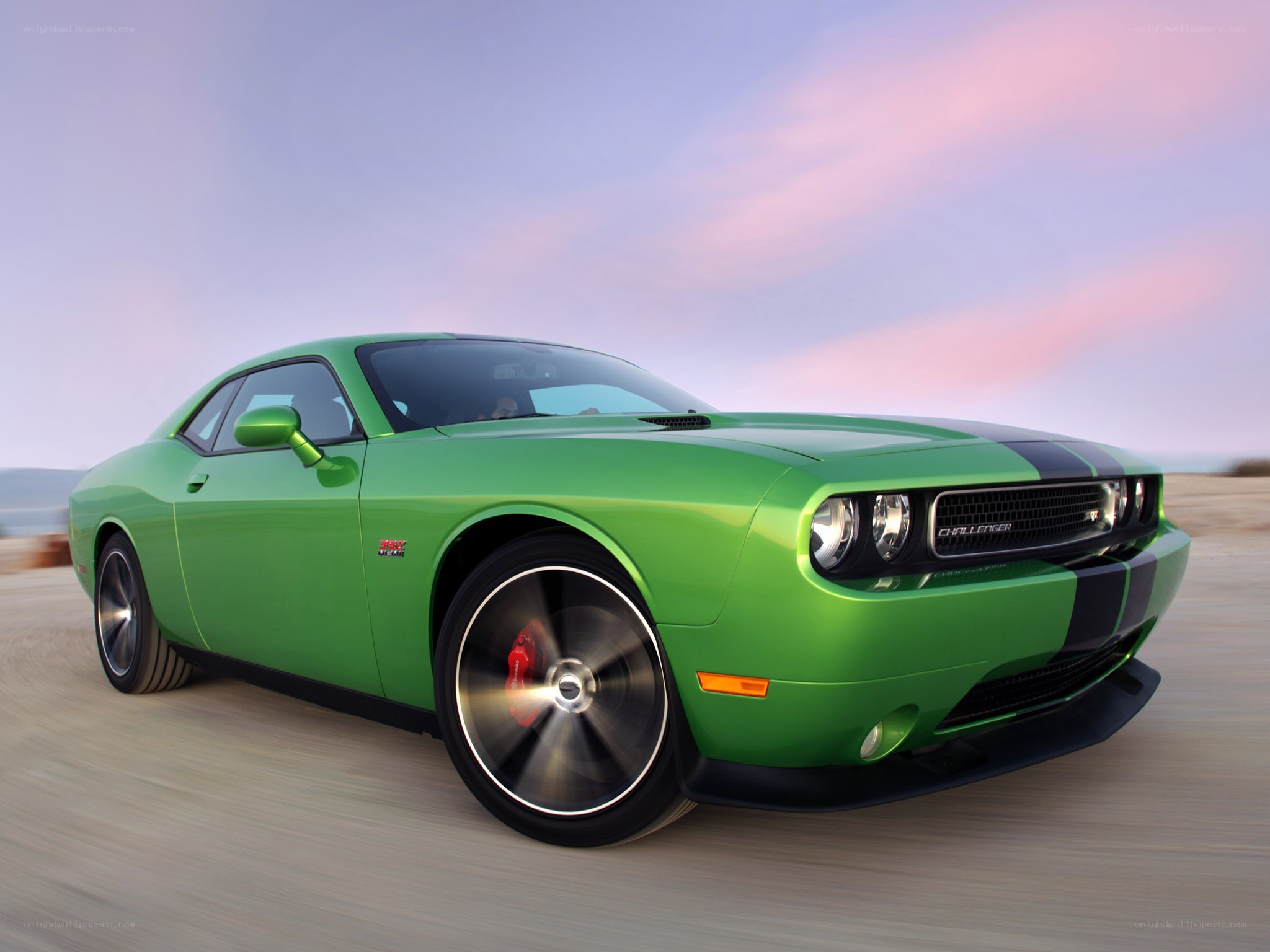 Green Dodge Challenger in motion