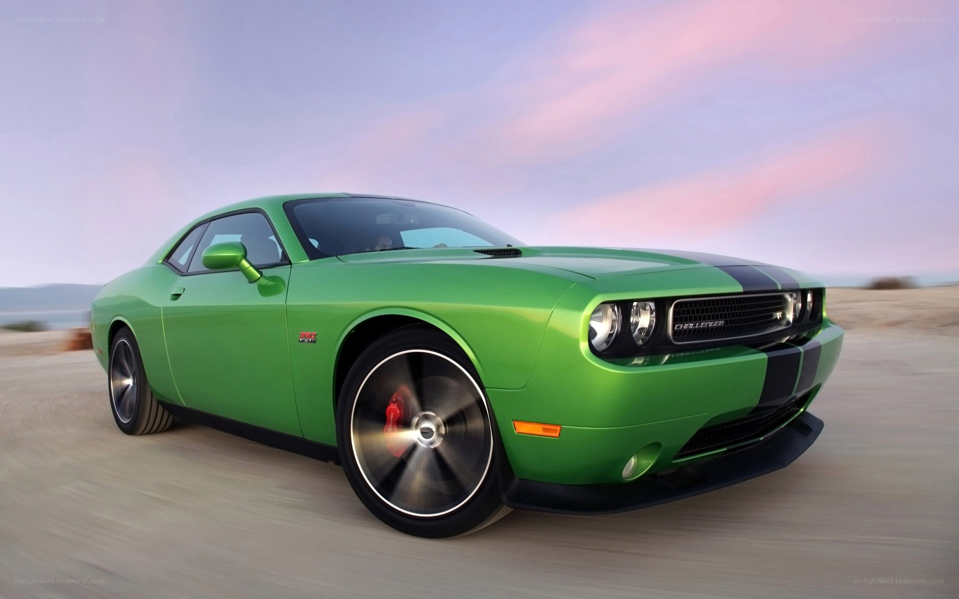 Green Dodge Challenger in motion