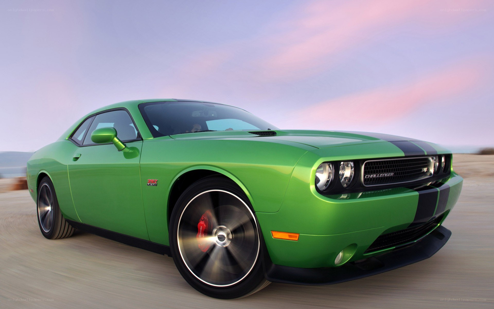 Green Dodge Challenger in motion