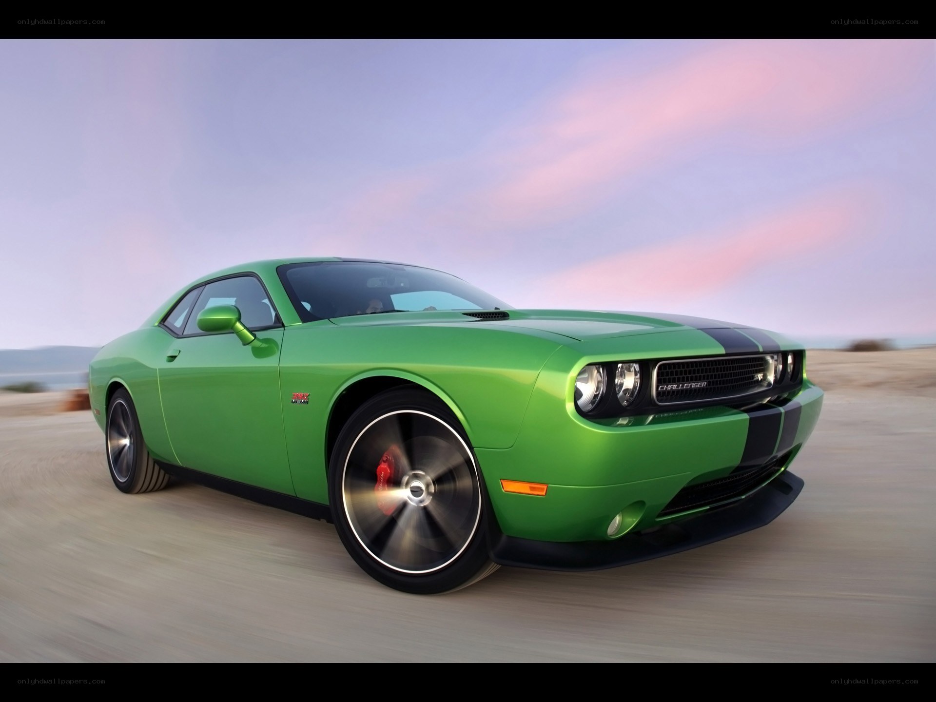 Green Dodge Challenger in motion