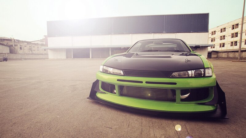 green drift car in parking lot