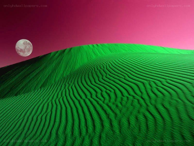 Green dunes under a pink sky
