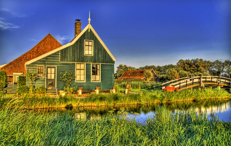 Green Dutch house by a canal