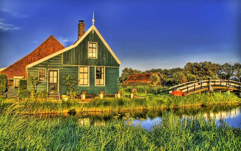Green Dutch house by canal