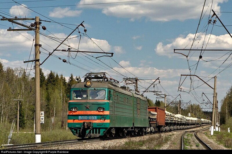 Green electric locomotive on track