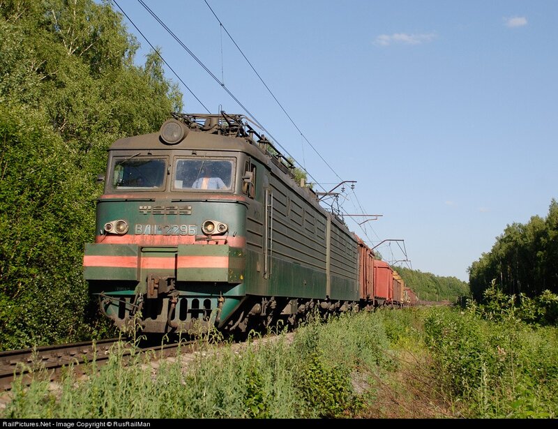 Green electric locomotive on track