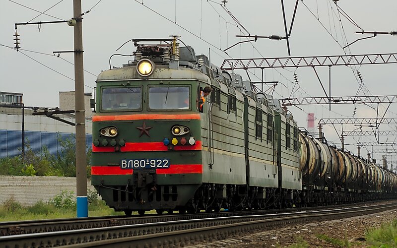 Green electric locomotive on tracks