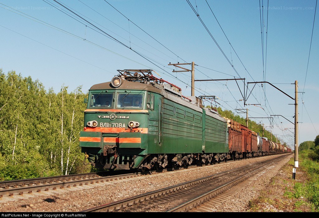 Green electric locomotive pulling freight