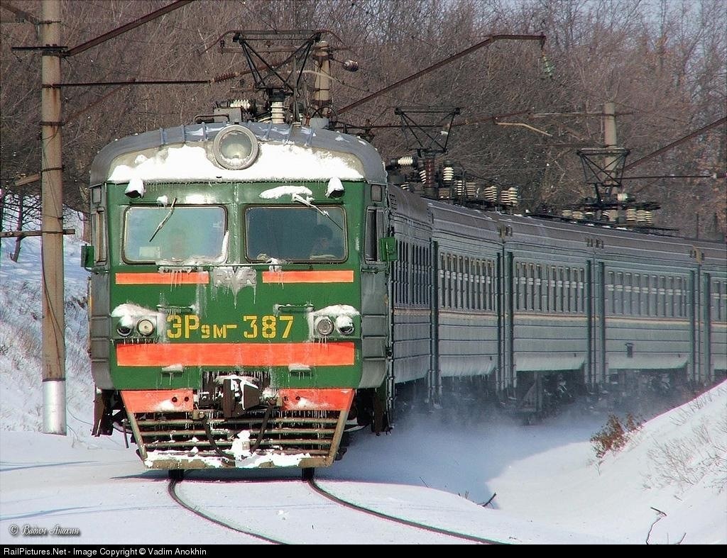 Green electric train in winter