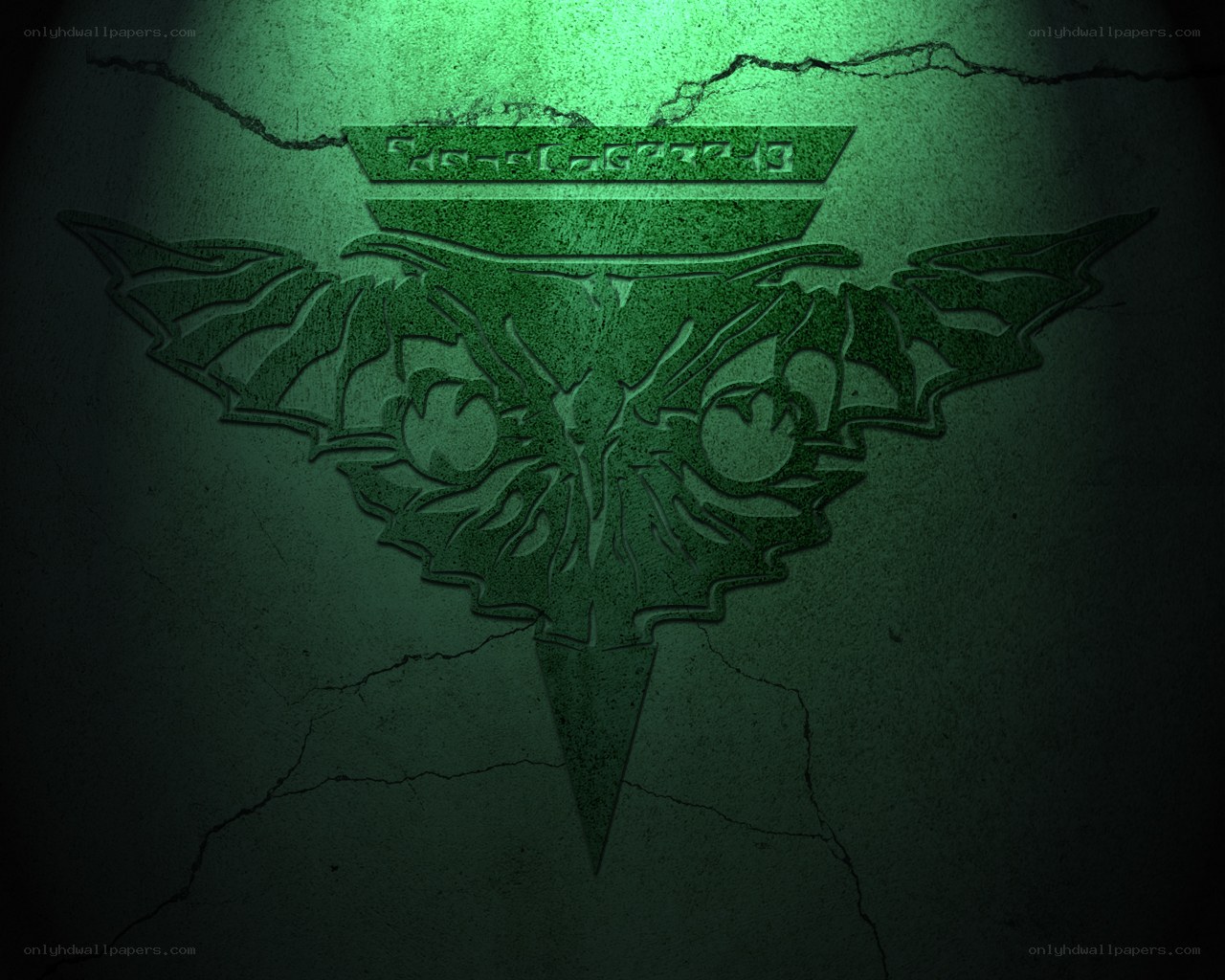 green emblem on cracked wall