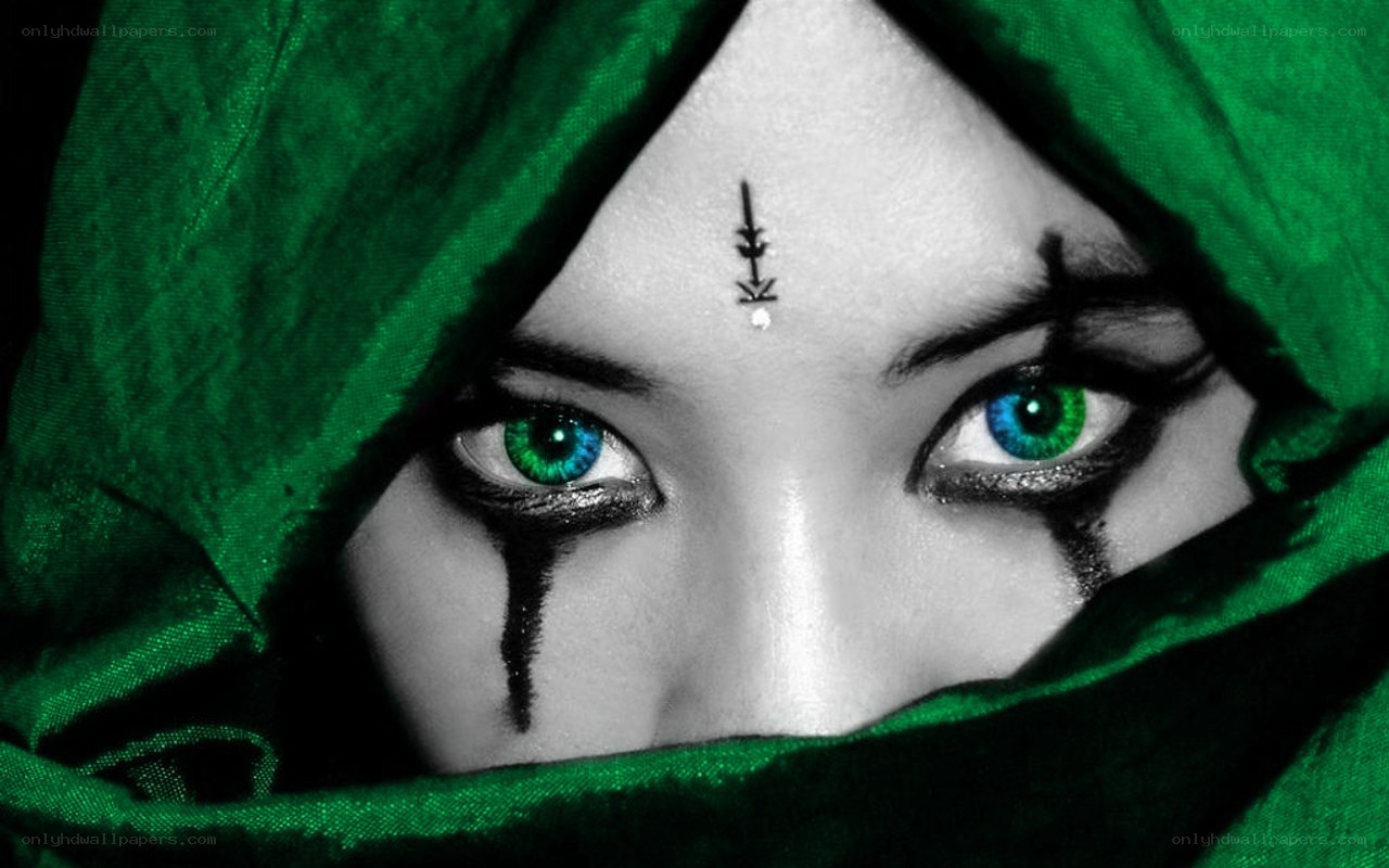 green-eyed figure in hood