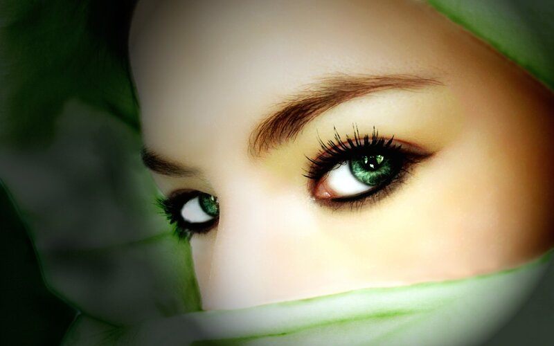 green-eyed woman with leaves