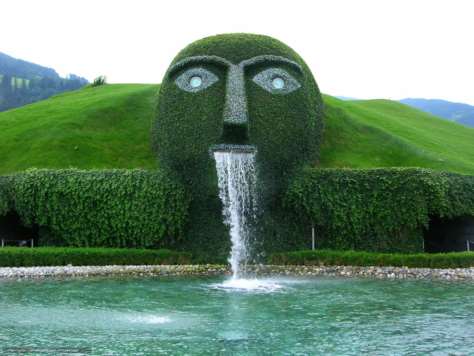Green face sculpture with waterfall