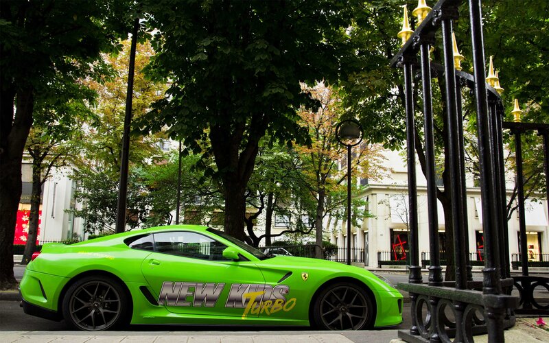 Green Ferrari on city street