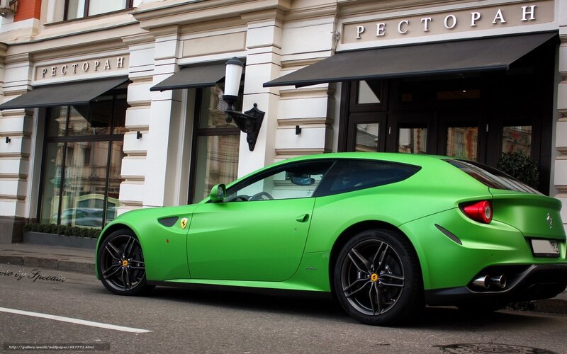 green ferrari on city street
