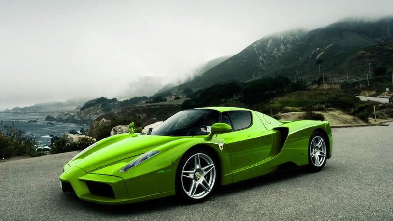 Green Ferrari on coastal road