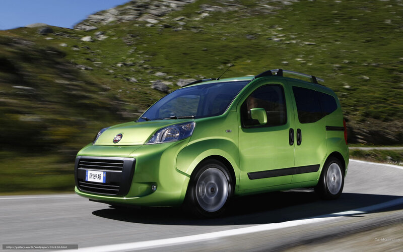 green fiat car on mountain road
