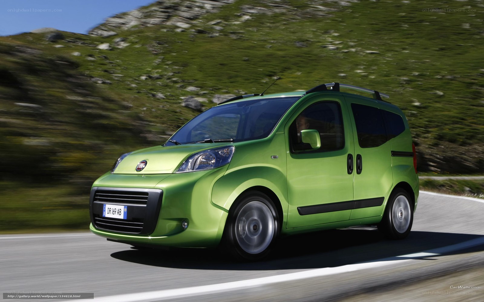 green fiat car on mountain road