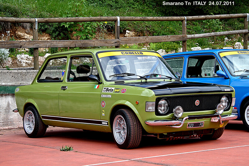Green Fiat race car at event