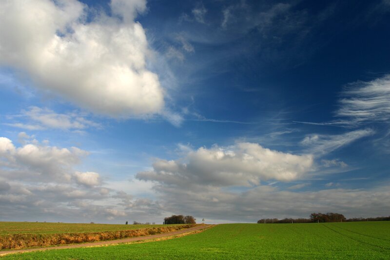 Green Field under Cloudy Sky — Blue, Serene, Afternoon, Photograph, Road