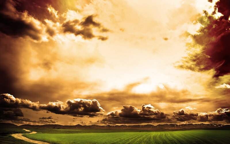 Green Field under Cloudy Sky — Dramatic, Sunset, Photograph, Road, Mountains