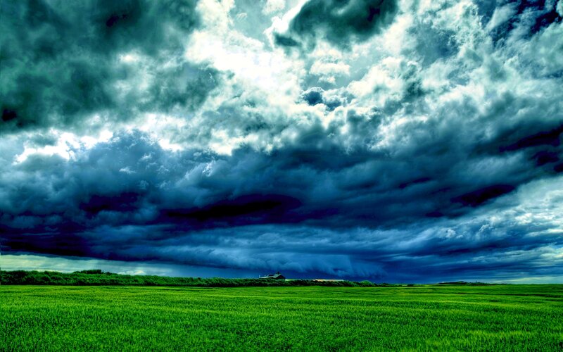 Green Field under Storm Clouds — Dramatic, Afternoon, Photograph, Building