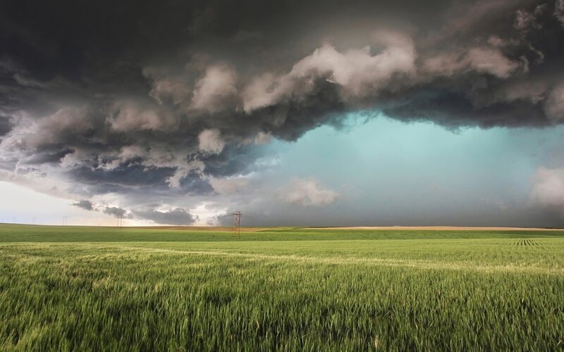 Green Field under Storm Clouds — Dramatic, Afternoon, Photograph, Tower