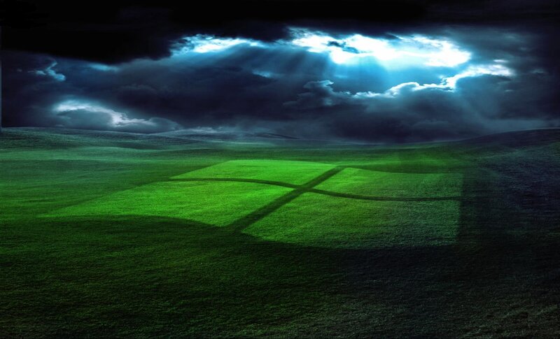 green field under stormy sky
