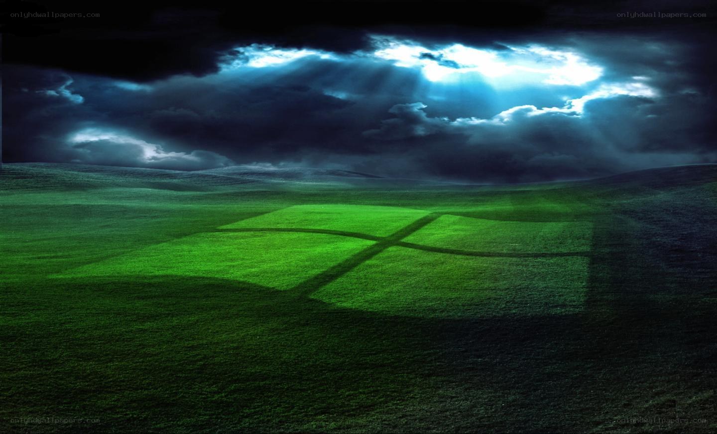 green field under stormy sky