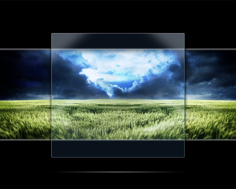 Green field under stormy sky
