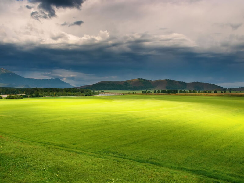 Green Field under Stormy Sky — Dramatic, Afternoon, Photograph, Mountains, Clouds