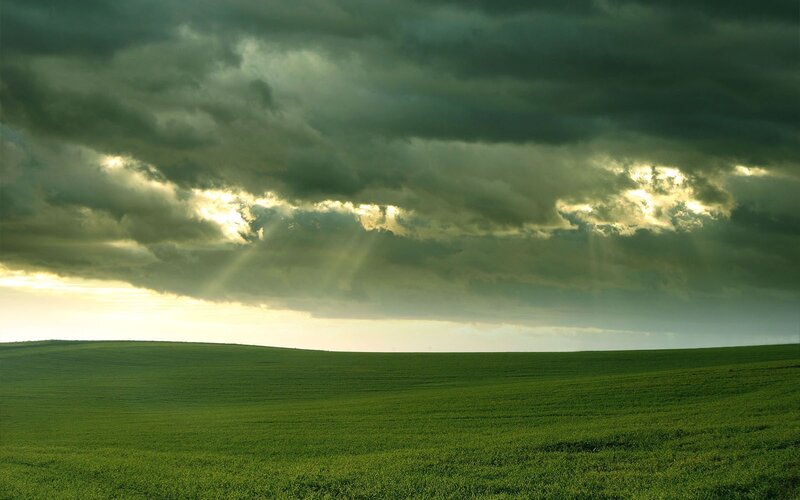 Green Field under Stormy Sky — Dramatic, Sunset, Photograph, Clouds, Sunlight