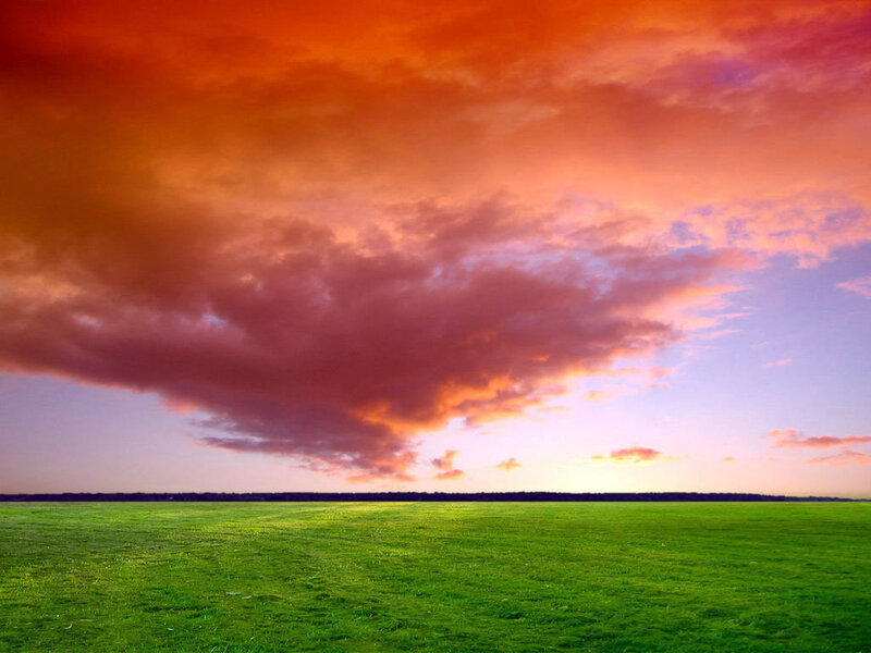 Green Field under Sunset Sky — Dramatic