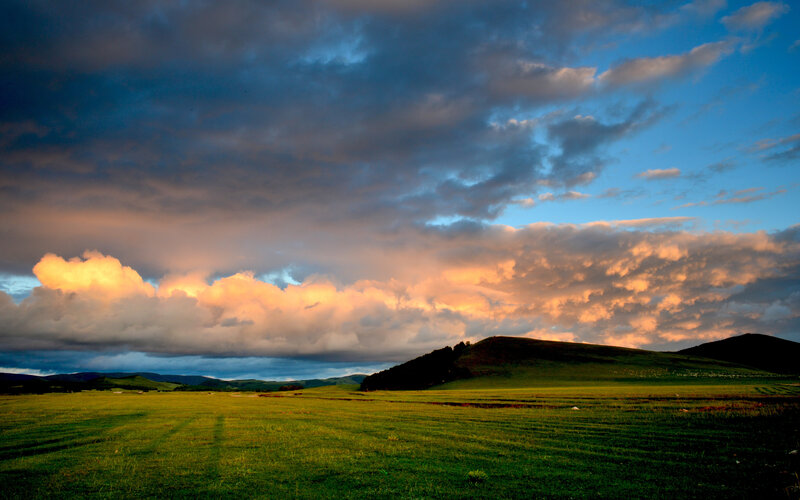 Green Field with Hills — Dramatic, Sunset, Photograph, Clouds