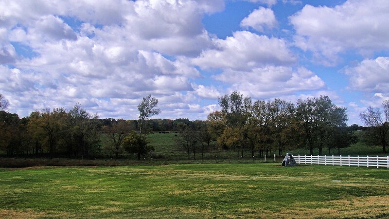 Green Field with White Fence