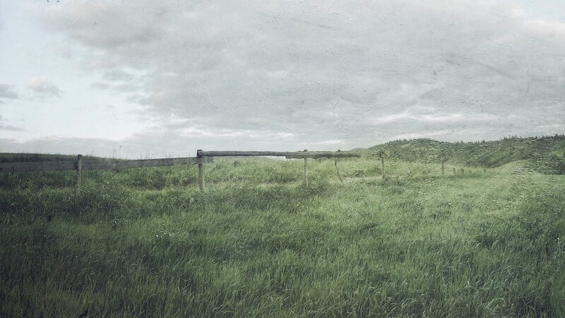 Green Field with Wooden Fence — Overcast